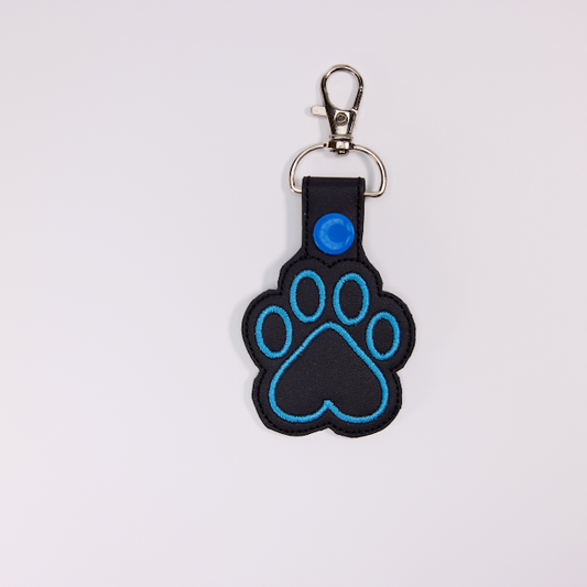Threadify Shop embroidered paw print keychain with blue stitching and black fabric base
