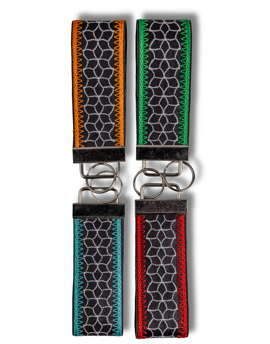 Threadify Shop handmade embroidered keychain set with colorful stitching and geometric black fabric design