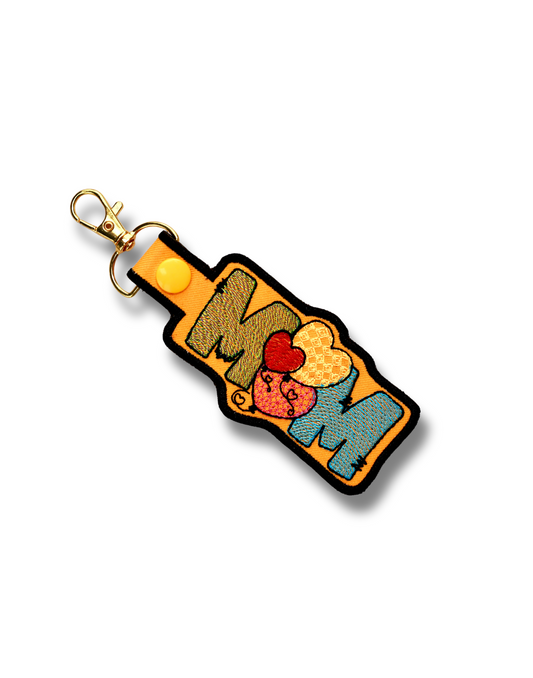 Handmade mom keychain with colorful embroidered letters and heart detail by Threadify Shop